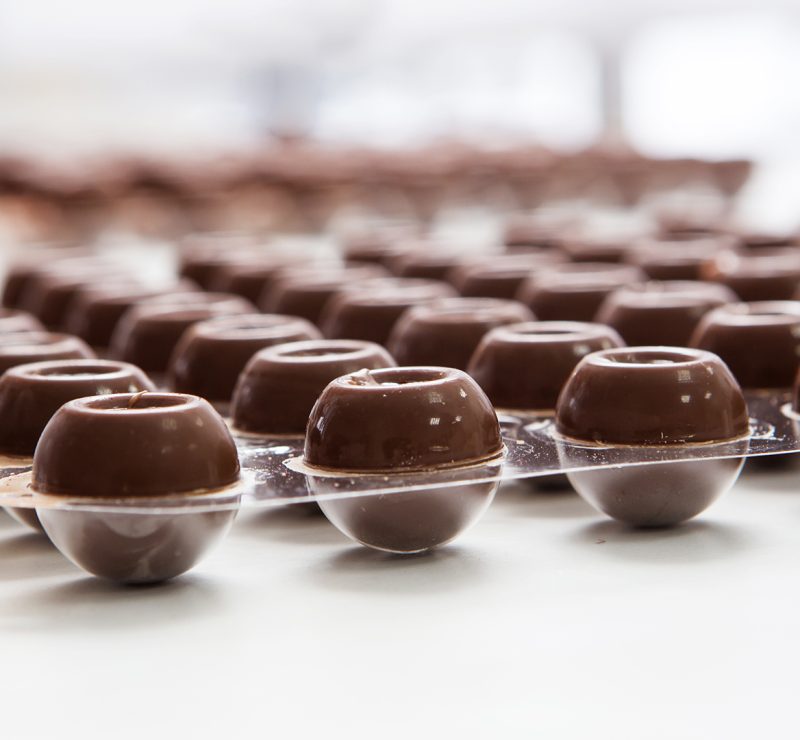manufacturing of handcrafted chocolate candies in daylight